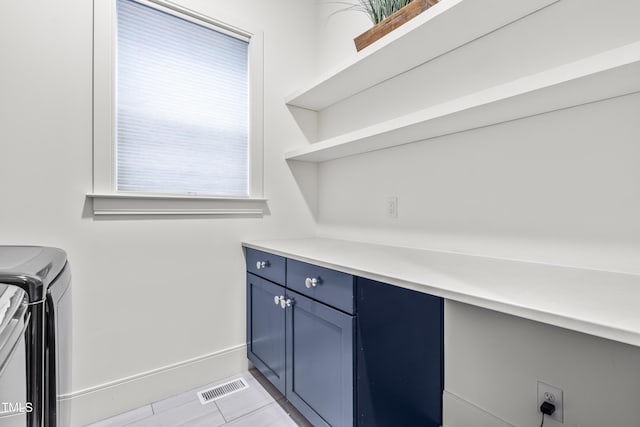 laundry room with visible vents, cabinet space, separate washer and dryer, and baseboards