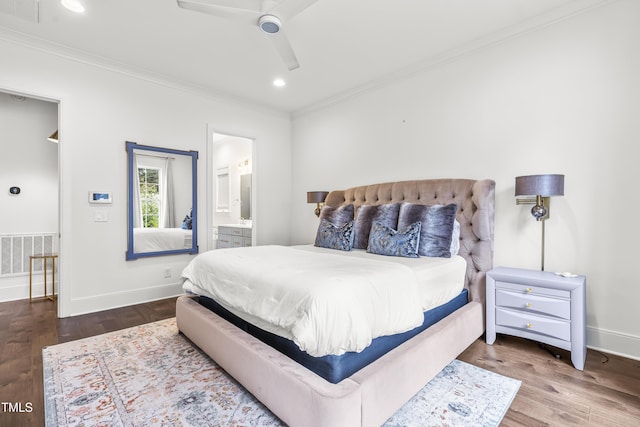 bedroom with wood finished floors, visible vents, and ornamental molding