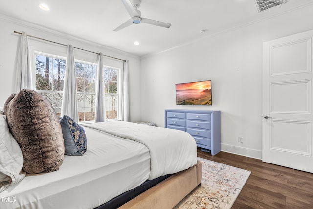 bedroom featuring visible vents, baseboards, ornamental molding, recessed lighting, and dark wood-style flooring