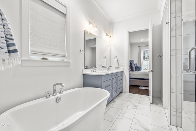 bathroom with marble finish floor, ensuite bath, crown molding, double vanity, and a freestanding bath