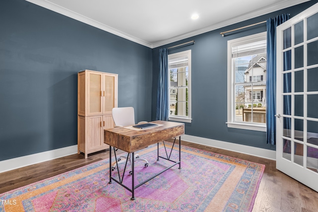 office space featuring baseboards, wood finished floors, and crown molding