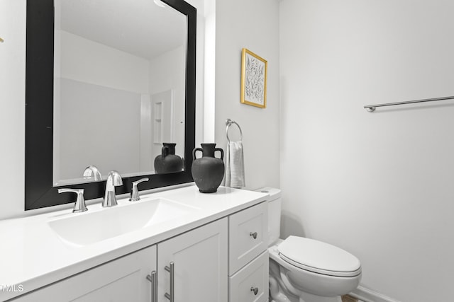 bathroom with toilet and vanity