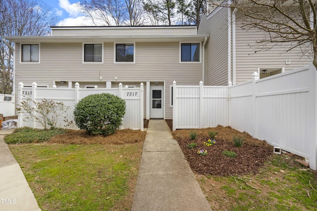 view of front of home featuring fence