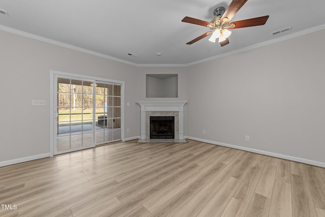 10133 Bessborough Dr, Raleigh, NC 27617 - unfurnished living room featuring visible vents, light wood finished floors, a fireplace, ornamental molding, and a ceiling fan