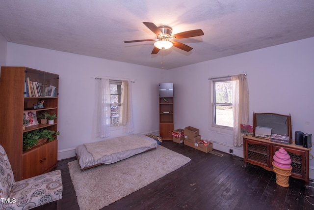 bedroom featuring wood-type flooring, baseboards, and ceiling fan