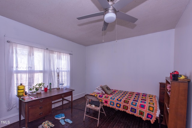 bedroom featuring ceiling fan, wood finished floors, and baseboards