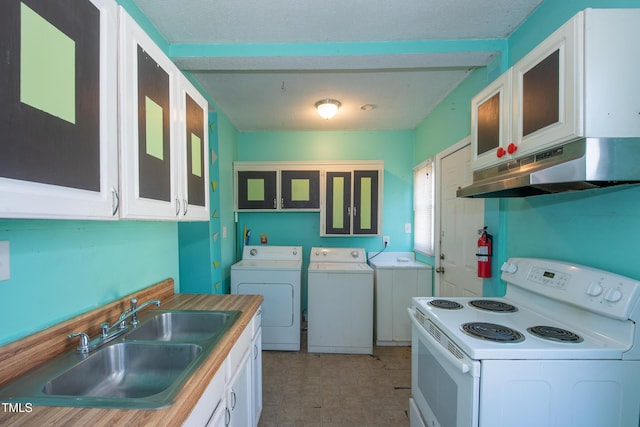 kitchen with washing machine and dryer, under cabinet range hood, white electric range, a sink, and white cabinets