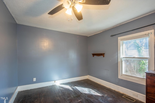 spare room with baseboards, visible vents, hardwood / wood-style flooring, ceiling fan, and a textured ceiling