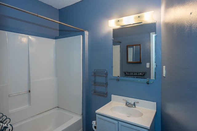 bathroom featuring  shower combination and vanity