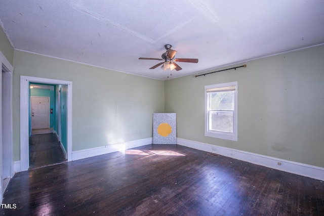 spare room with hardwood / wood-style flooring, ceiling fan, and baseboards