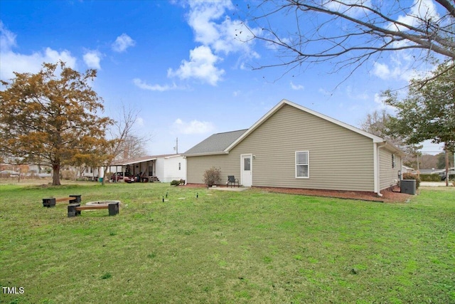 view of side of property with a lawn and central AC unit