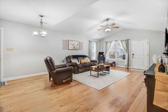 living room with vaulted ceiling, ceiling fan with notable chandelier, light wood-type flooring, and baseboards