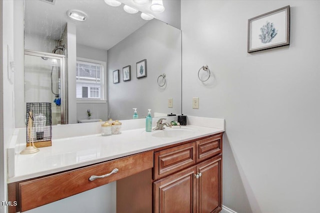 bathroom with a stall shower and vanity