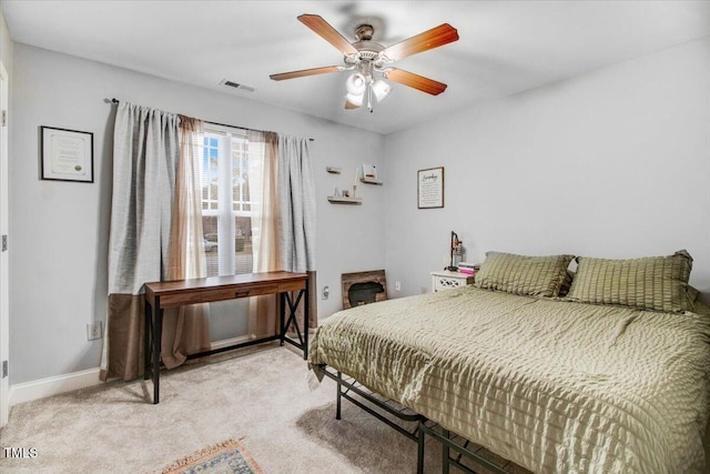 carpeted bedroom featuring visible vents, ceiling fan, and baseboards