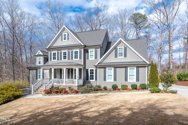 view of front of home featuring covered porch and roof with shingles