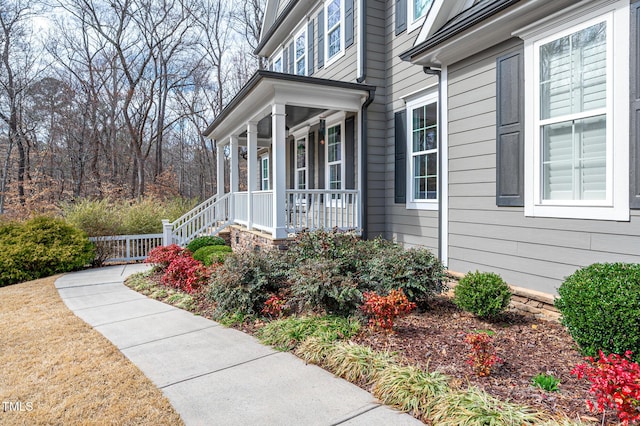 view of exterior entry featuring covered porch