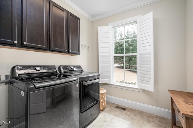 laundry room with visible vents, baseboards, washer and dryer, cabinet space, and crown molding