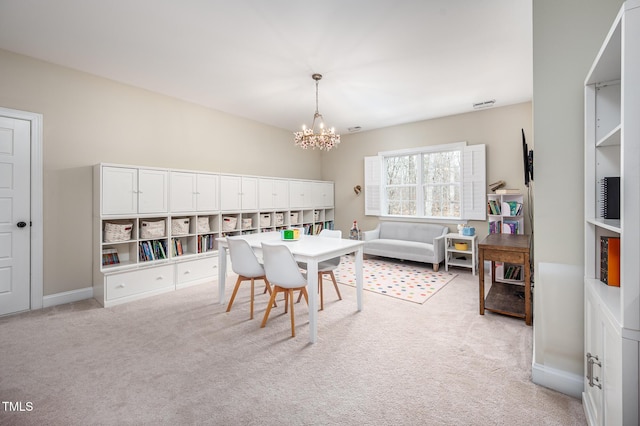 dining area with light carpet, baseboards, visible vents, and a notable chandelier