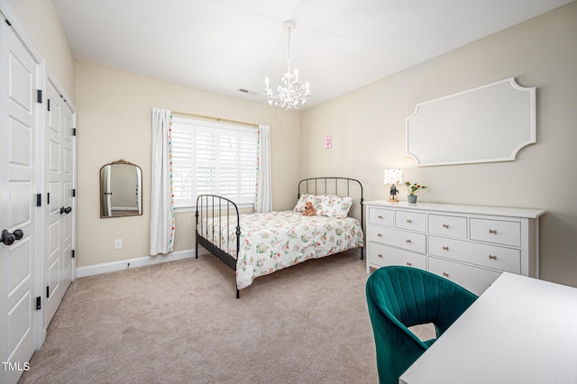 carpeted bedroom with visible vents, a chandelier, and baseboards