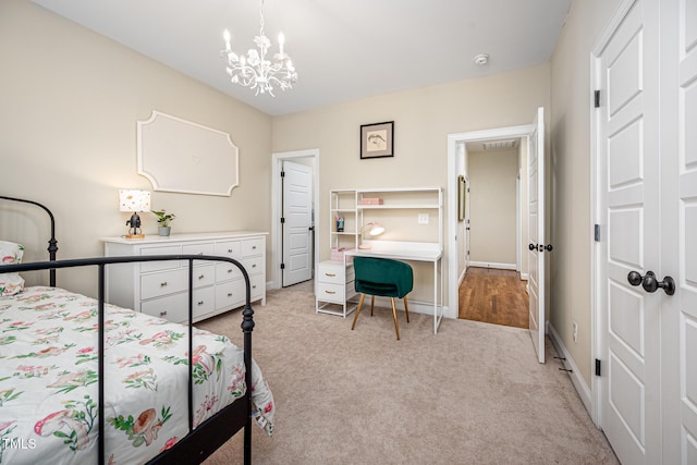 bedroom with light carpet, baseboards, and a chandelier