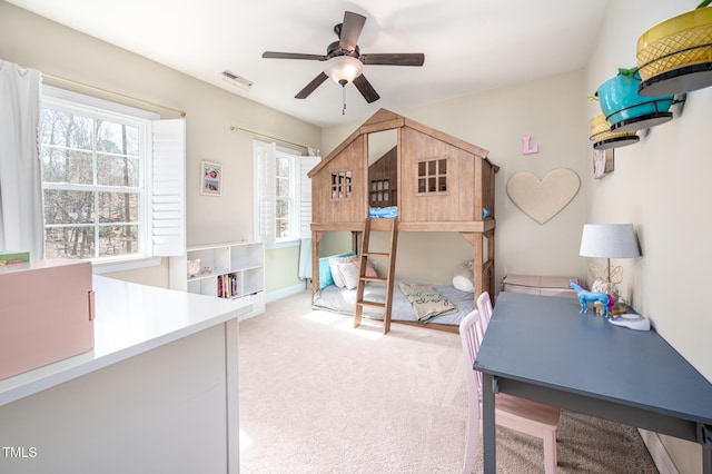 bedroom featuring light carpet, ceiling fan, and visible vents