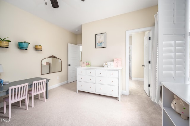 bedroom featuring light carpet and baseboards