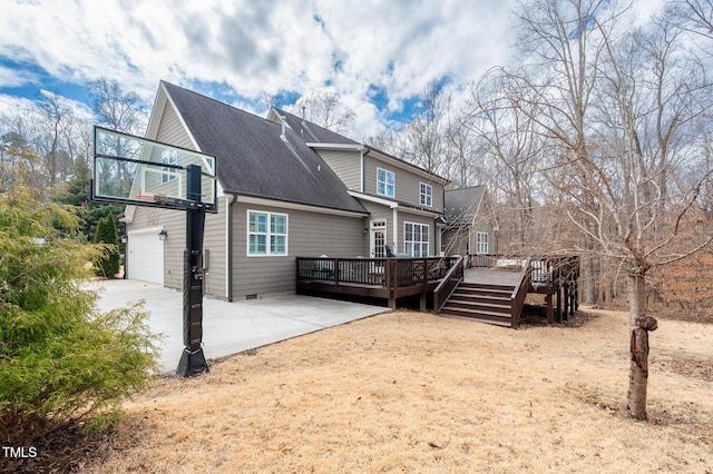 rear view of house with a deck, a garage, a shingled roof, concrete driveway, and crawl space