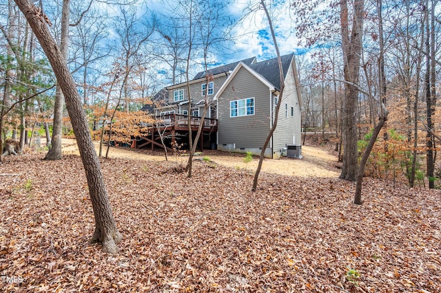 back of property featuring a shingled roof, crawl space, a deck, and central AC unit