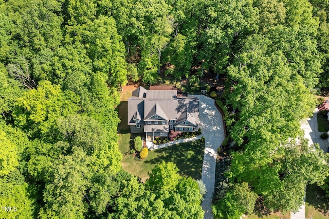 birds eye view of property featuring a wooded view