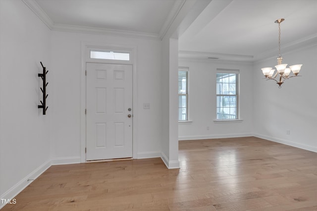 entryway featuring crown molding, light wood-style flooring, baseboards, and a chandelier