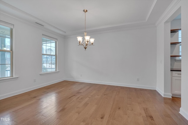 unfurnished dining area featuring visible vents, crown molding, light wood finished floors, baseboards, and a chandelier