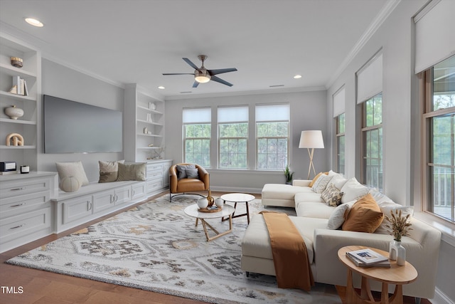 living room featuring built in features, recessed lighting, wood finished floors, and ornamental molding