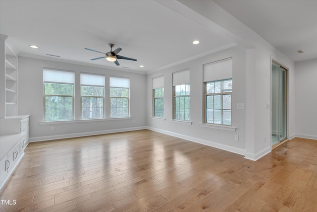 unfurnished living room featuring recessed lighting, baseboards, light wood-style flooring, and ornamental molding