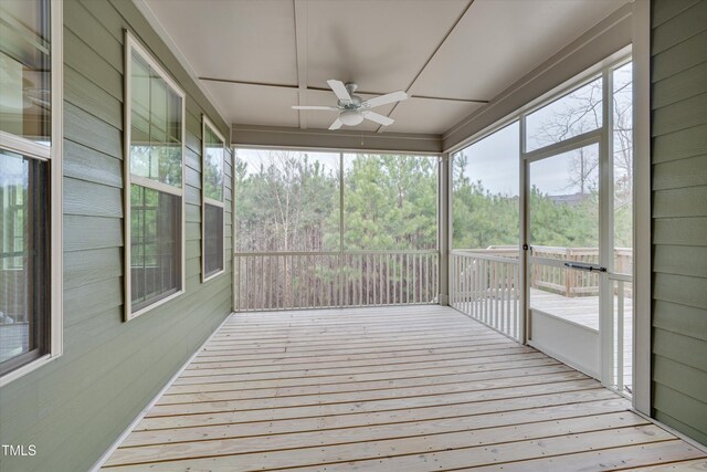 unfurnished sunroom with a ceiling fan