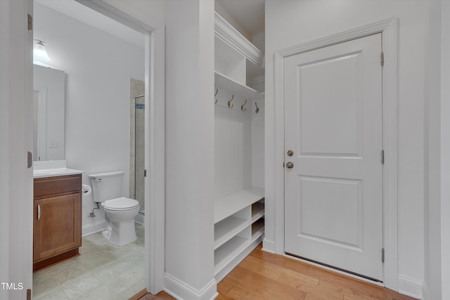 mudroom featuring baseboards and light wood-style flooring