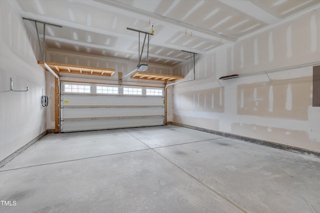 garage featuring a garage door opener and baseboards