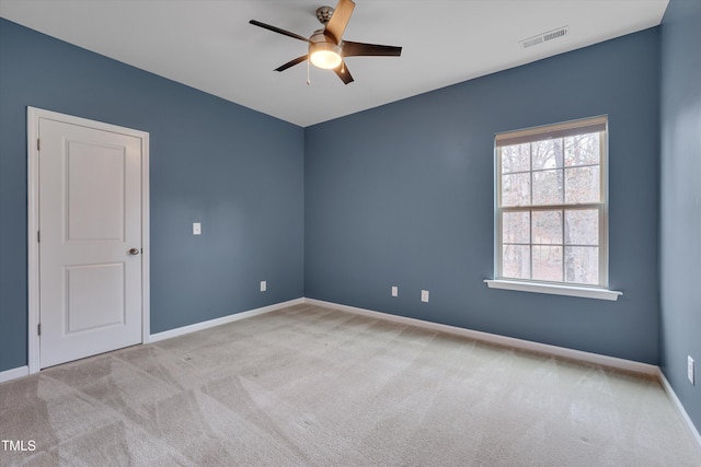 unfurnished room with baseboards, carpet, visible vents, and ceiling fan