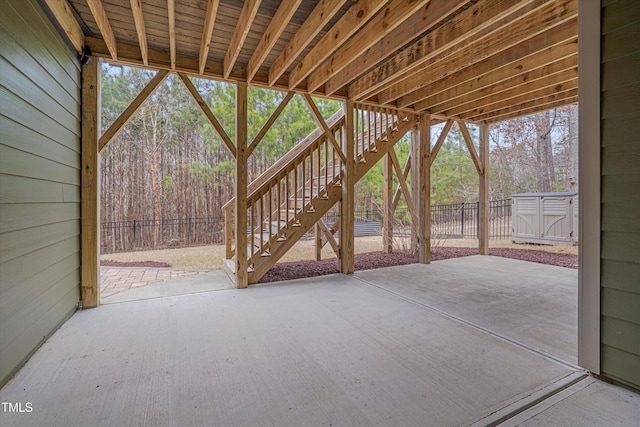 view of patio featuring stairs and fence