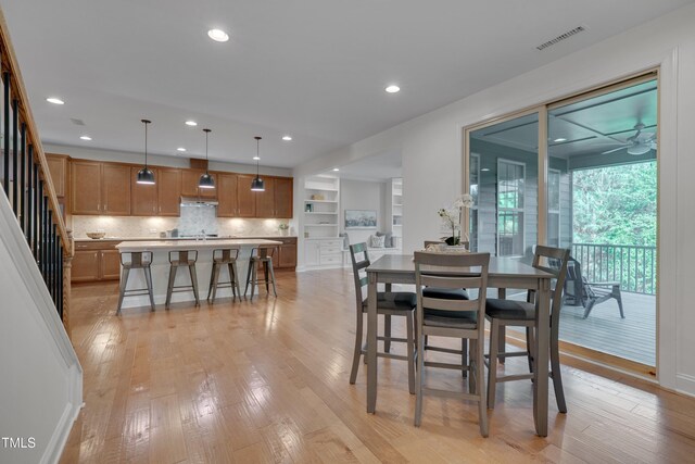 dining room featuring recessed lighting, light wood finished floors, visible vents, ceiling fan, and stairs