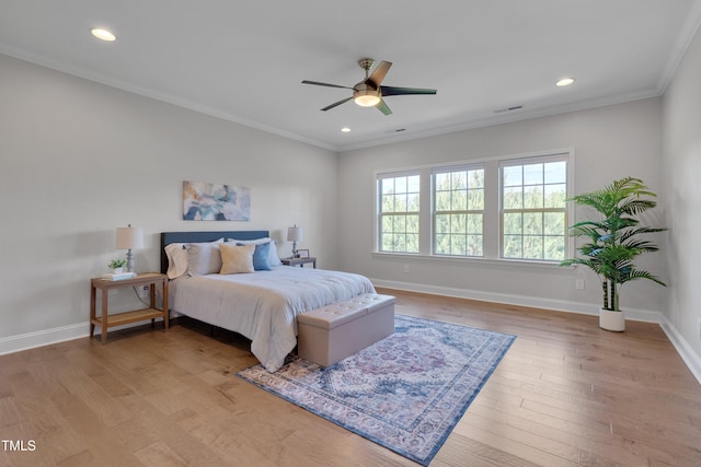 bedroom with crown molding, light wood-type flooring, and recessed lighting