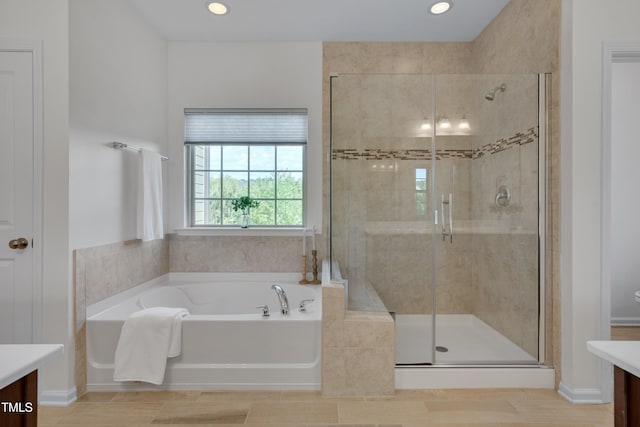 bathroom featuring a shower stall, vanity, recessed lighting, and a bath