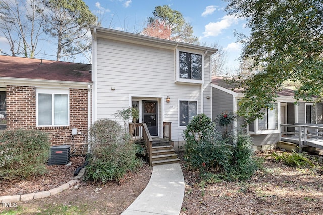 view of front of property with brick siding and central AC unit