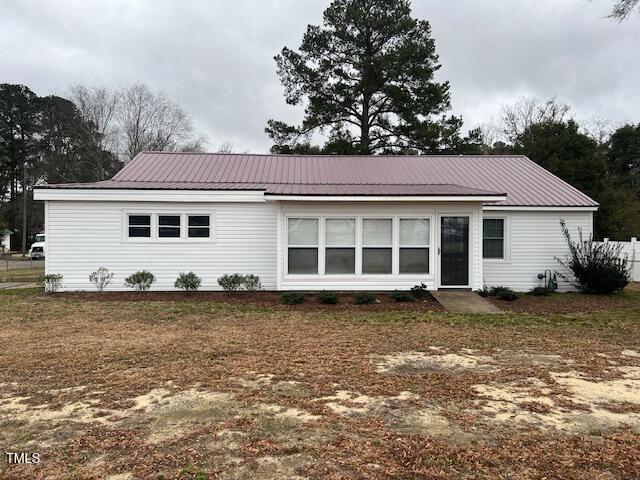 back of property featuring metal roof