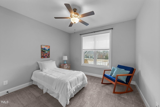 bedroom with ceiling fan, baseboards, and carpet flooring