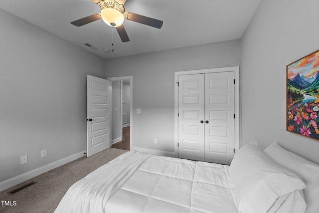 carpeted bedroom featuring ceiling fan, a closet, visible vents, and baseboards