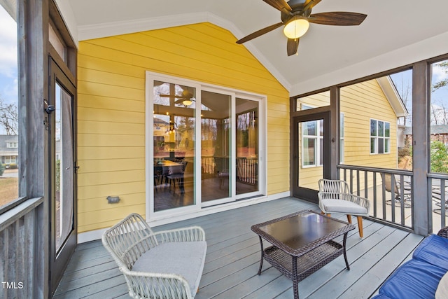 sunroom featuring vaulted ceiling and ceiling fan