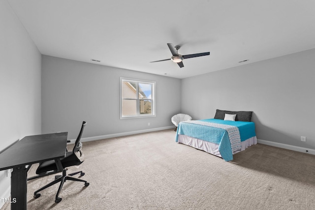 carpeted bedroom featuring a ceiling fan, visible vents, and baseboards