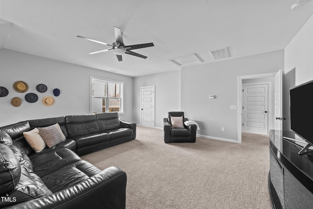 carpeted living area featuring a ceiling fan, attic access, visible vents, and baseboards