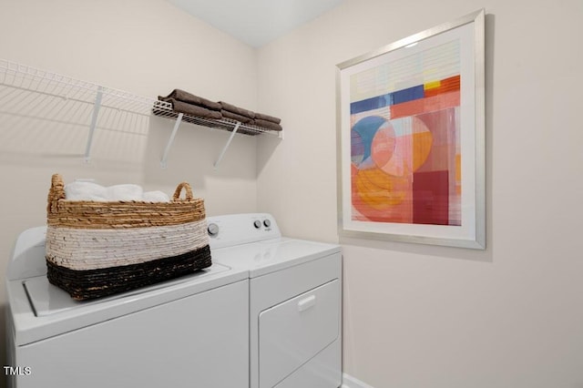 clothes washing area featuring laundry area and washer and dryer