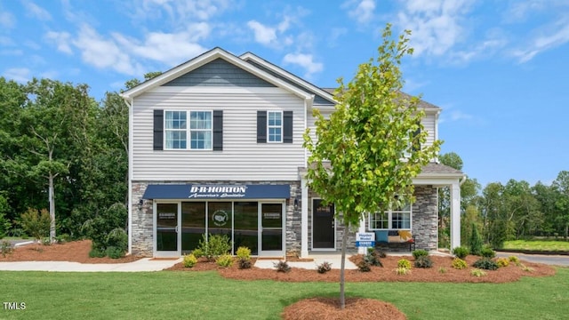 view of front of property featuring stone siding and a front lawn